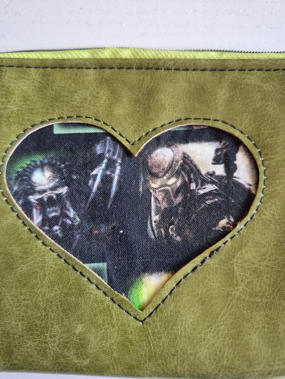Olive green heart pouch w/ alien hunter appliqued on front pouch